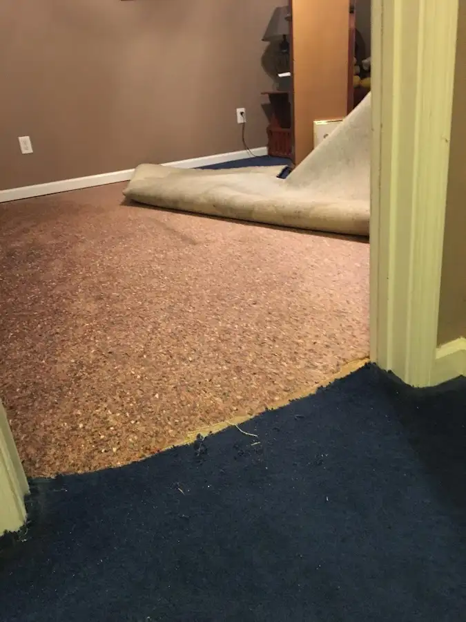 Carpet pad removal revealing water damage during Water Mitigation Services in San Carlos